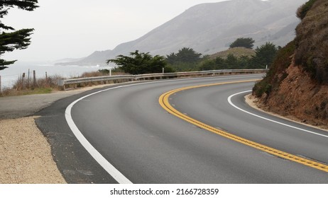 Pacific Coast Highway 1, Cabrillo Road Along Ocean, Foggy California, Big Sur, USA. Coastal Road Trip, Traveling On Car By Sea. Cloudy Misty Weather. Yellow Dividing Line, Asphalt. Turn Of Serpentine.