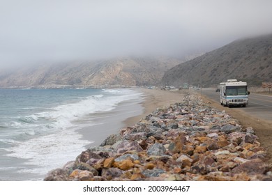 Pacific Coast Highway With Fog And An Old RV Camper Or Caravan.