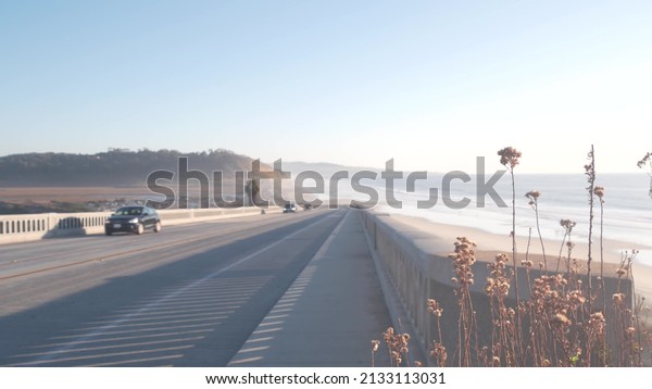Pacific coast highway, Torrey Pines state beach,\
cars driving on road 1, freeway 101 from San Diego to Del Mar.\
Ocean sea waves, coastal roadtrip aesthetic, traveling during\
vacations. California\
USA.