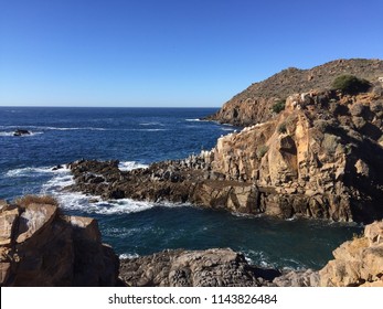 Pacific Ocean blue water viewed from a cliff at Ensenada Mexico and an amazing clear sky in the background