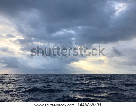 Pacific Ocean view with small waves and storm squall in background