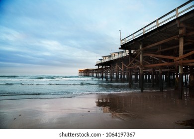 Pacific Ocean Waves Crash On Crystal Pier In Pacific Beach. Old Wooden Pier In San Diego California Beach And Boardwalk.