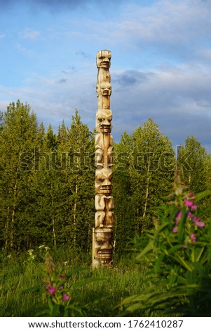 pacific totem pole in front of forest