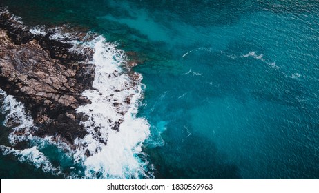 Pacific waves crashing on the rocky coast of Kapalua bay in Maui Hawaii