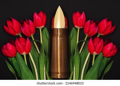 Pacifism, Non-violence Movement Or Victory Day. Big Bullet And Bunch Of Red Tulips.