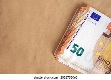 Pack of 50 euro banknotes on a recycled brown paper
