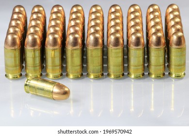 pack of bullet 11 mm or .45 acp FMJ (Full Metal Jacket ) ready for use, isolate on white background reflection surface.