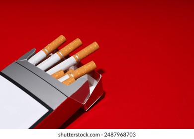 A pack of cigarettes on a red background