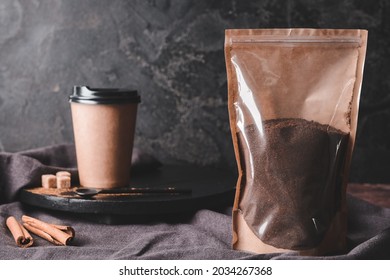 Pack With Coffee Powder And Cup To-go On Dark Background