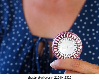 Pack Of Female Hormonal Pills For Pregnancy Prevention, Contraception Or Hormone Replacement Therapy. A Woman Is Holding A Round Package.