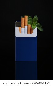 Pack Of Menthol Cigarettes And Mint On Black Background