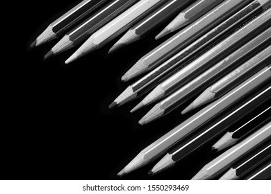 A pack of pencils on a dark background close up. Black and white