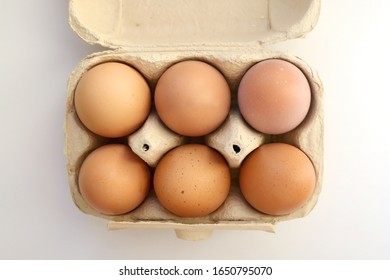 Pack Of Six Free Range Eggs On White Background. Top View.