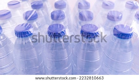 Pack of small shrink-wrapped water bottles. Plastic water bottle pollution concept