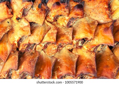 A Pack Of Smoked Flounder With Golden Crust. Background