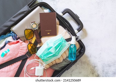 Pack Travel Luggage,Open Suitcase Packed For Travelling, Close Up,Vacation During Pandemic ,Packing Up For Winter Holiday: An Open Suitcase Full Of Clothes And Other Objects Ready To Be Packed