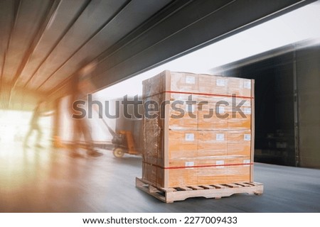 Package Boxes Wrapped Plastic Stacked on Pallets Loading into Cargo Container. Loading Dock Distribution Supplies Warehouse. Shipping Supply Chain Shipment. Freight Truck Logistics Cargo Transport	
