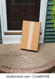 A Package Is Delivered To A Residential House And Left Out In The Open Which Could Lead To Theft.