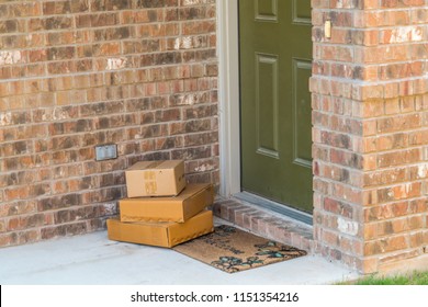 Package Delivery On Doorstep. Boxes And Postal Delivery On Modern Brick Home Doorstep On Front