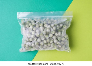 Package With Frozen Pea On Green Background, Concept Of Saving Leftovers.