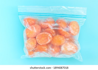 Package With Frozen Tomatoes On Blue Background, Concept Of Saving Leftovers.