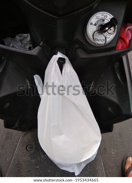 a package
hanging on a hanger on a
motorcycle
