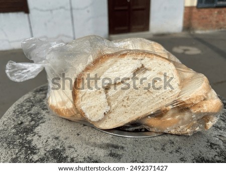 Packaged bread on a top of a garbage can