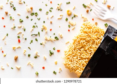 packaged instant noodles with spices on a white background - Shutterstock ID 1290978721