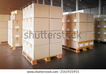 Packaging Boxes Stacked on Pallets in Storage Warehouse. Cartons Cardboard Boxes. Supply Chain. Storehouse Distribution. Shipping Supplies Warehouse Logistics.	
