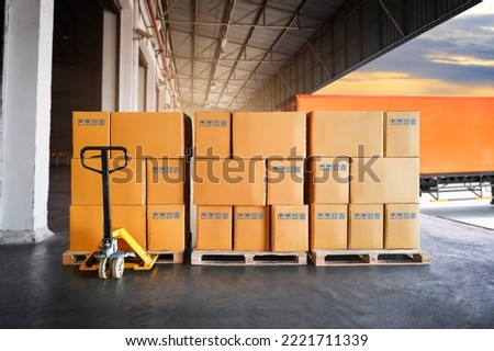 Packaging Boxes Stacked on Pallets Wating to Loading into Cargo Container.  Cartons, Cardboard Boxes. Delivery Shipping Trucks. Supply Chain Shipment Goods. Distribution Supplies Warehouse Logistics.