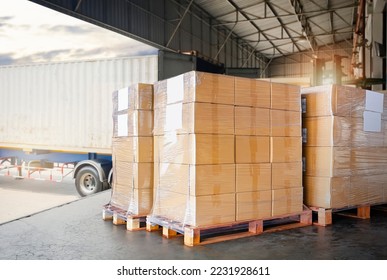 Packaging Boxes Wrapped Plastic on Pallets Loading into Cargo Container. Distribution Supplies Warehouse. Shipping Trucks. Supply Chain Shipment Boxes. Freight Truck Transport Logistics.	