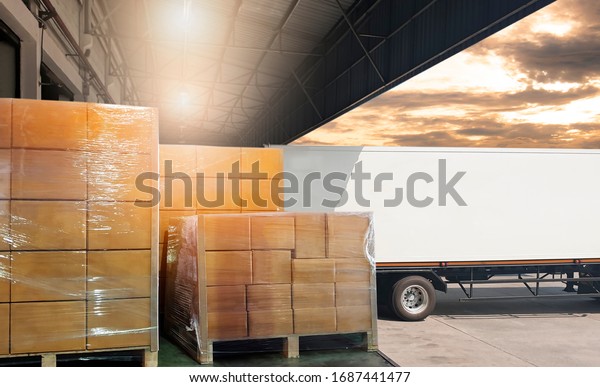 Packaging Boxes Wrapped Plastic Stacked on\
Pallets Loading into Cargo Container. Shipping Trucks. Supply\
Chain. Shipment Boxes. Distribution Supplies Warehouse. Freight\
Truck Transport\
Logistics.