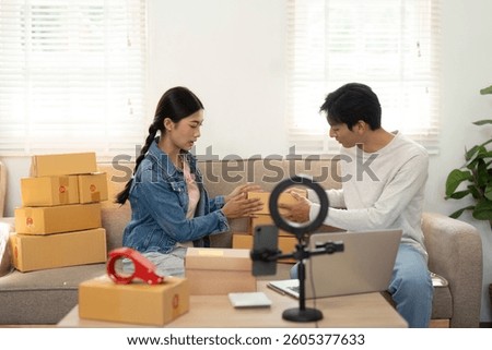 Packaging and Creativity. A couple organizing their products for an online business while sharing ideas.