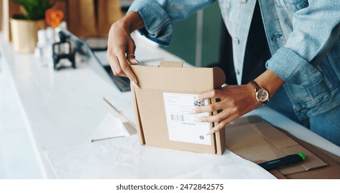 Packaging, hands and startup in workplace for delivery, online order and distribution from boutique. Female entrepreneur, box and product on table for supply, ecommerce and customer service in retail