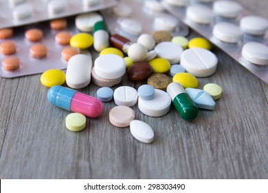 Packaging of tablets and pills on the table. Medicine - Shutterstock ID 298303490