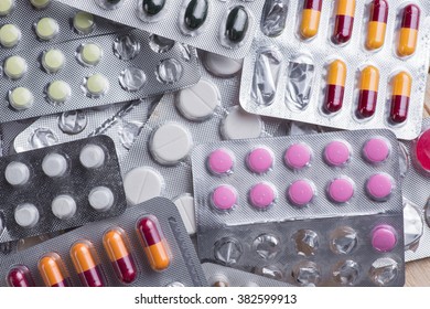 Packaging of tablets and pills on the table - Shutterstock ID 382599913