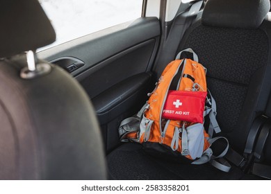 A packed backpack containing a wellstocked first aid kit is securely placed in the back seat, which is essential for ensuring safety and convenience during family outings or long road trips