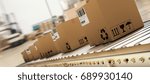 Packed courier on production line against  cardboard boxes in warehouse