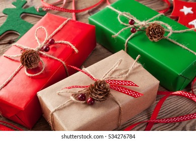 Packed red and green present box on vintage wooden board