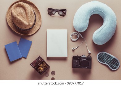 Packed Suitcase Of Vacation Items On Wooden Table, Top View. Vintage Style