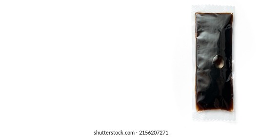 A Packet Of Single-Use Soy Sauce In Plastic Flatlay Isolated On White Background With Shadow