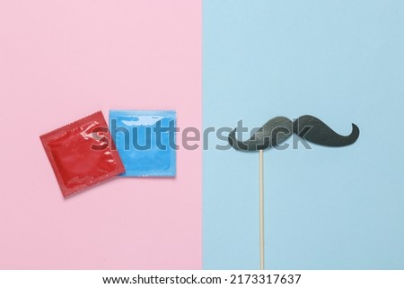 Packets of condoms with a mustache on a stick. Blue pink pastel background