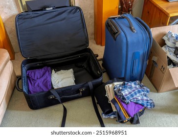 Packing clothes into suitcases for travel, vacation, moving, or leaving home - Powered by Shutterstock