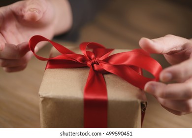packing gift box with red ribbon
