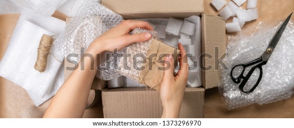 Packing products for delivery, shipping service.\
Delivery concept for private companies delivery with care , Craft\
present box