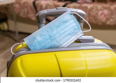 Packing Suitcase Luggage Including Face Mask And Sanitizer To Protect Coronavirus Covid-19, Travel.