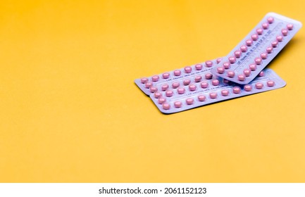 ฺBlister packs of contraceptive pills on yellow background. Hormone pills for treatment hormone acne. Birth control pills. World Contraception Day. Pharmacy banner. Prescription drugs. Hormone pills.