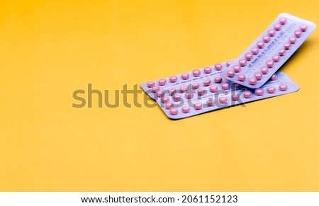 ฺBlister packs of contraceptive pills on yellow background. Hormone pills for treatment hormone acne. Birth control pills. World Contraception Day. Pharmacy banner. Prescription drugs. Hormone pills. [[stock_photo]] © 