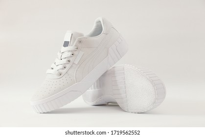 A packshot photography of light-grey sneakers isolated on white background