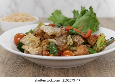 Pad Kee Mao Authentic Thai Food Served With A Side Order Of Brown Rice For A Complete Meal.